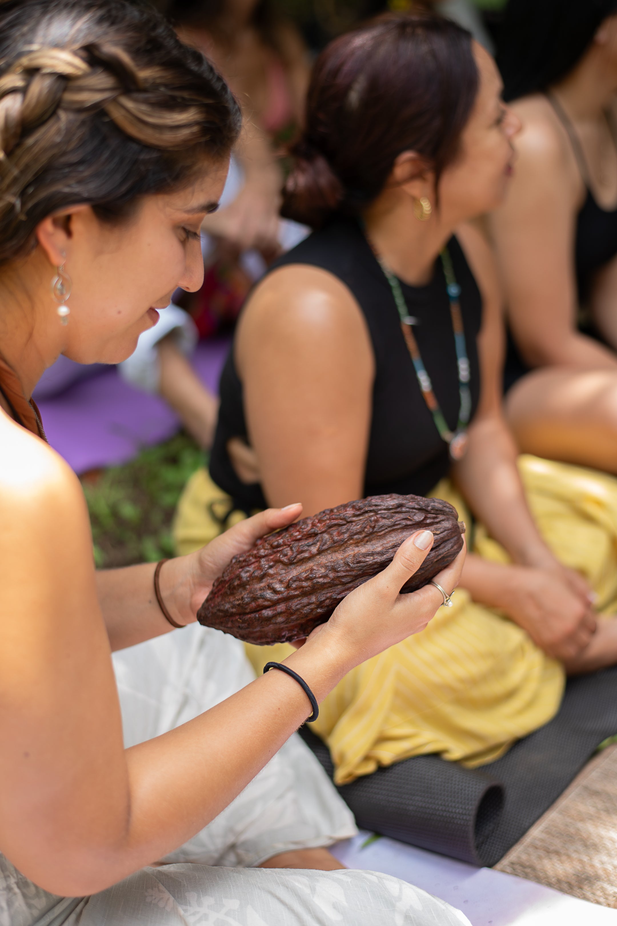 A woman holding a cacao fruit