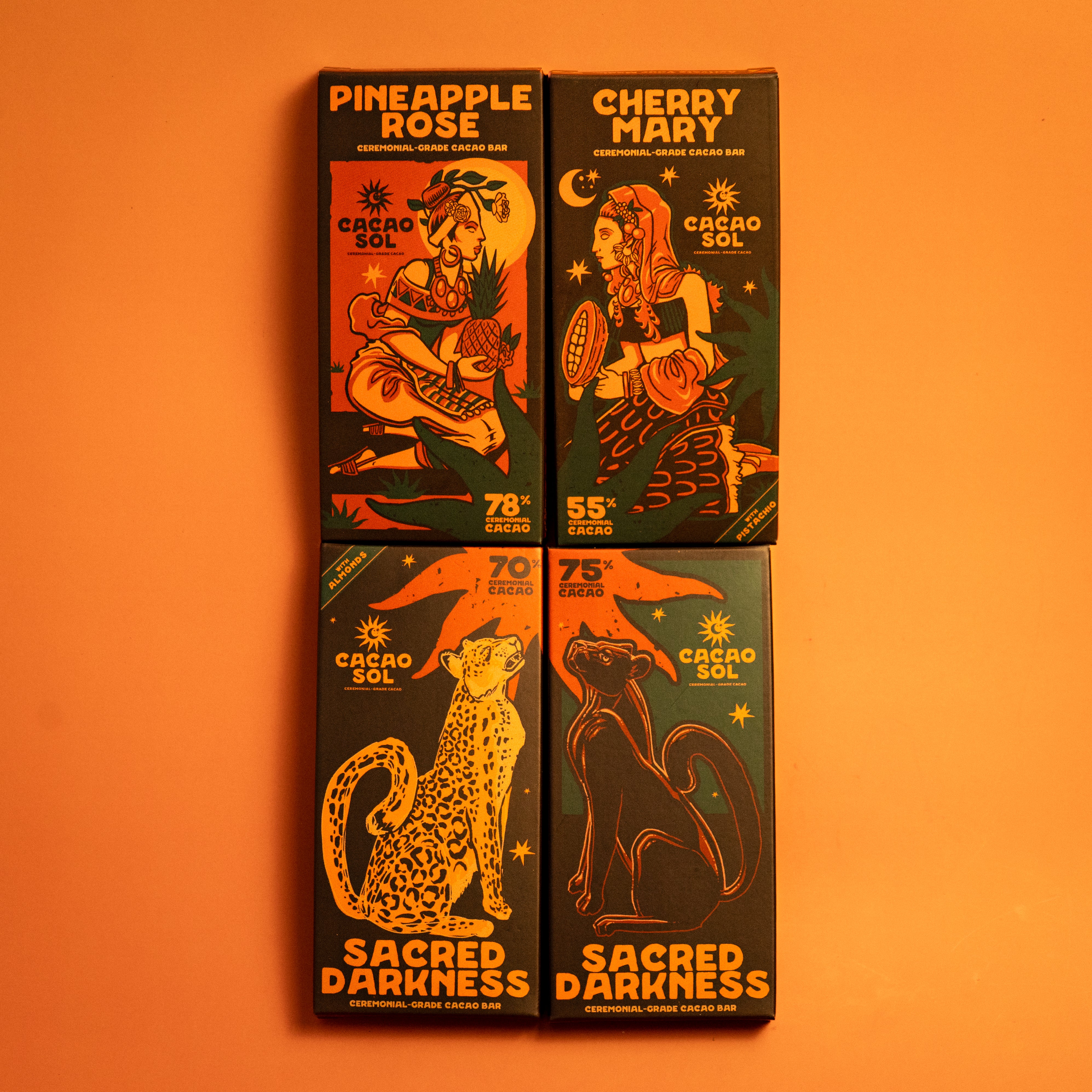 Four  Cacao Sol chocolate bars with illustrations and text on an orange background