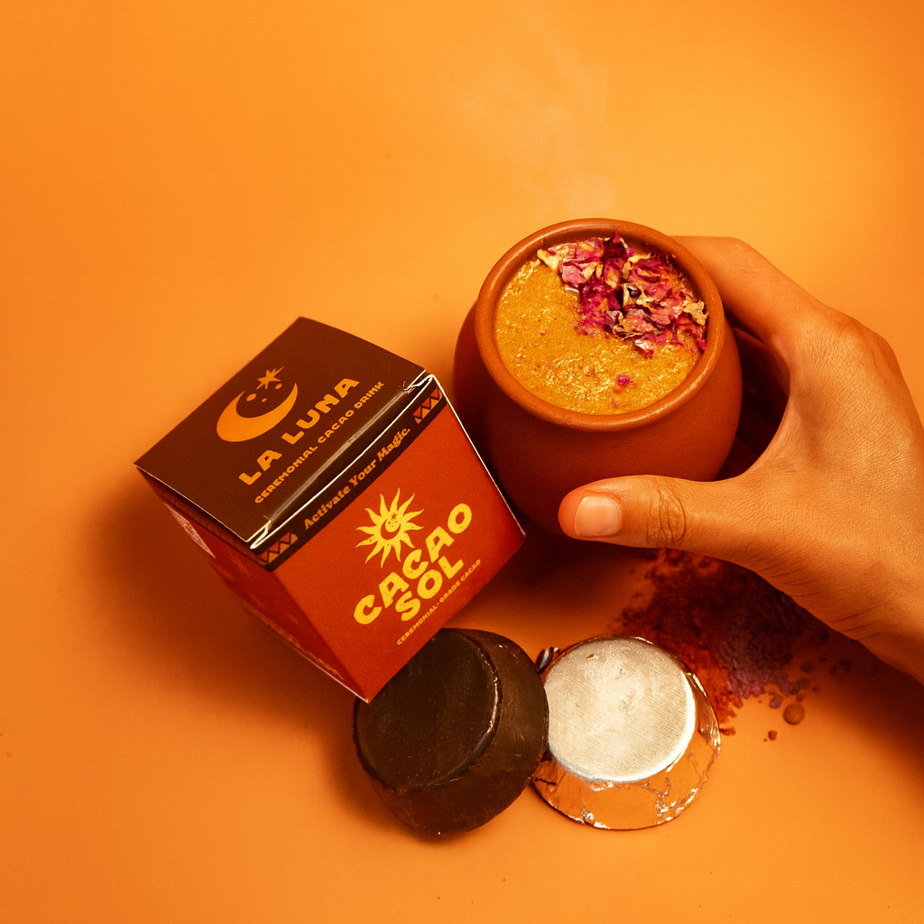 La Luna ceremonial cacao drinking blend packaged and an orange background